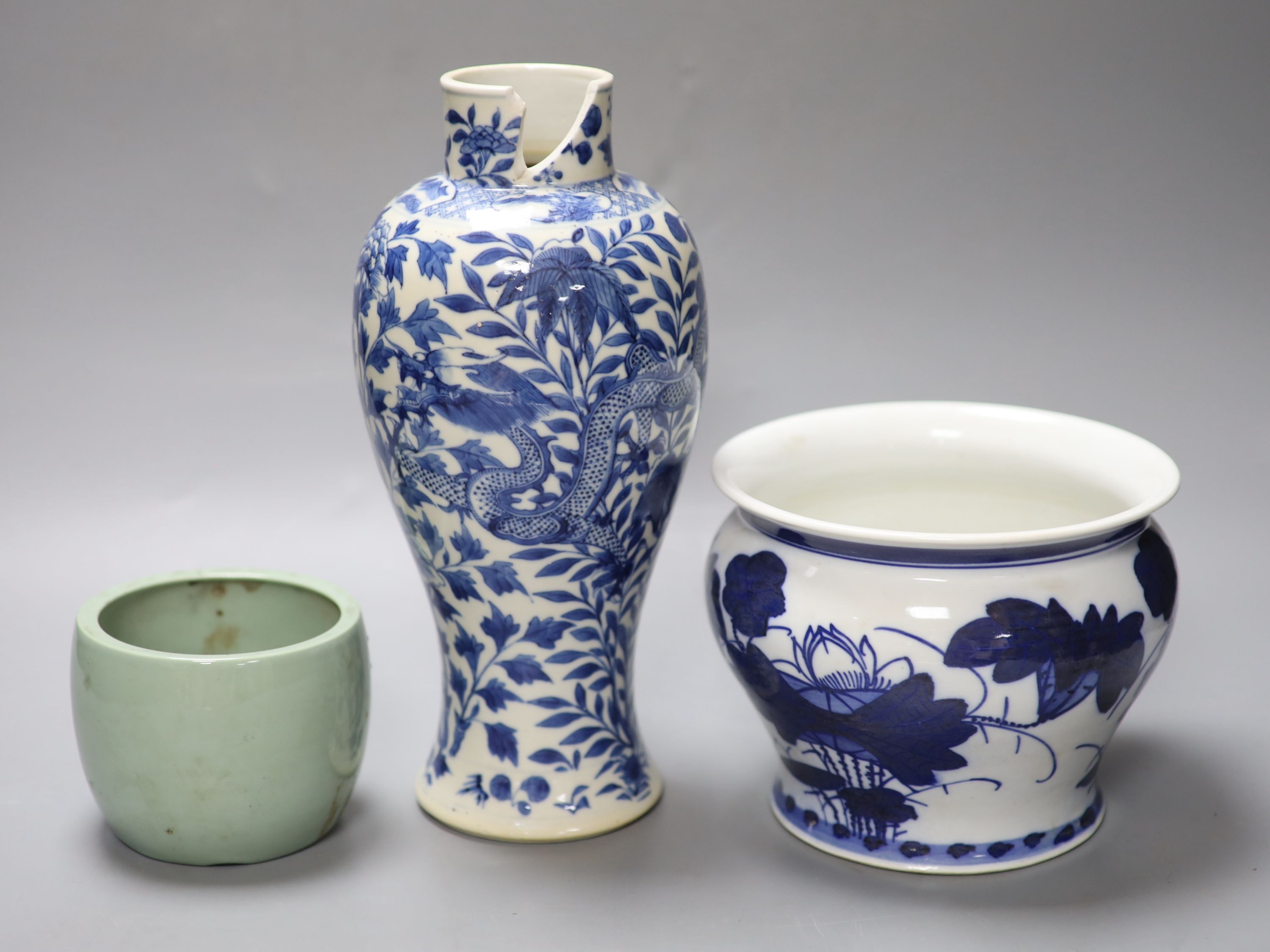 A Chinese blue and white dragon vase with Kangxi mark, together with a blue and white jardiniere and a celadon glazed bowl